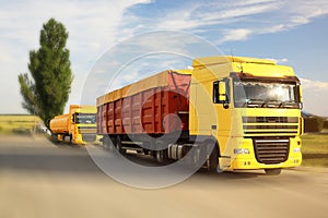 Logistics. Trucks on country road, motion blur effect