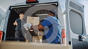 Logistics Warehouse Two Happy Diverse Workers Talk, Joke use Hand Pallet Truck Start Loading