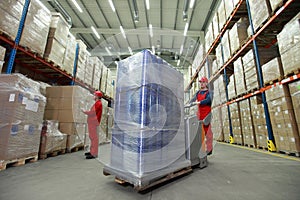 Logistics - workers in storehouse photo