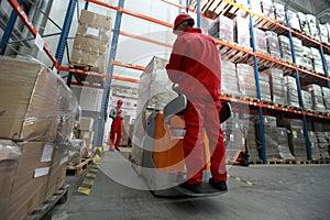 Logistics workers at work in storehouse