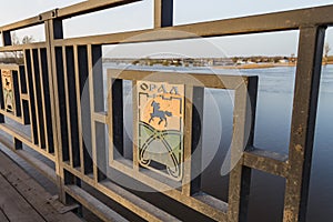 The logo of the city of Uralsk on the railing of a road bridge. Road bridge over the Ural River.