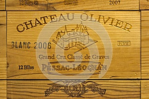 Logo of French winery Chateau Olivier on wooden wine box.