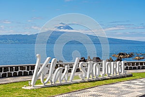 Logo, letters of the parish of Velas SÃ£o Jorge, view of the island of Pico. photo