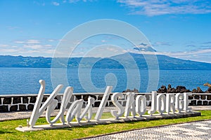 Logo, letters of the parish of Velas SÃ£o Jorge, view of the island of Pico. photo