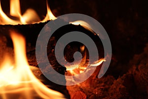 Logs burning with flames in a fireplace