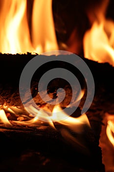 Logs burning with flames in a fireplace