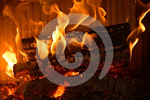Logs burning in the hearth of a fireplace