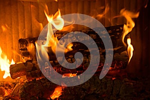 Logs burning in the hearth of a fireplace
