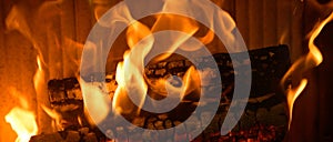 Logs burning in the hearth of a fireplace