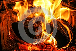 Logs burning hot in fire place.