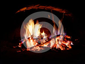 Logs burning in the oven. Flames and heat on the wood. Hot logs