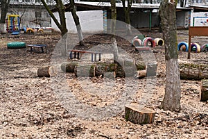 logs of felled trees on the playground of the kindergarten.