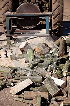 Logs and tractor driven saw.