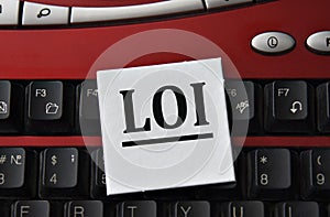 LOI - abbreviation on a white sheet against the background of a computer keyboard