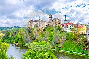 Loket Castle Hrad Loket gothic style building on massive rock over Eger river and colorful buildings in Loket town