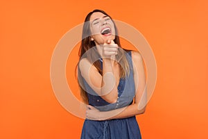 Lol, hey you! Excited joyful brunette woman laughing out loud, holding her belly and pointing finger to camera