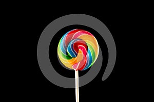 Lollipop, Big Round Rainbow colored lollipop isolated on dark pink black background