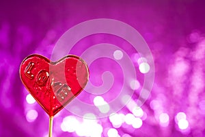 Lollipop heart on pink background