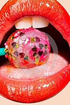 Lollipop with hearts in the mouth. Sweet kiss on Valentine`s day. Caries for white teeth. Sweets for girls. Seductive