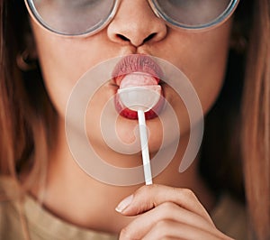 Lollipop, woman and lips with lipstick, cosmetics and gen z style eating a sweet candy. Mouth, young person and food