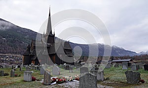 Lom Stavkirke stave church and graveyard in autumn in Norway