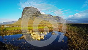 Lomagnupur Mountain, a precipitous promontory on the south coast of Iceland.Amazing Icelandic landscape with water mirror.