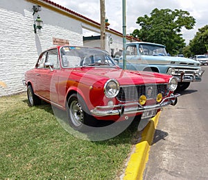 sporty red Fiat 1500 coupe Vignale fastback built in Argentina, late 1960s. CADEAA 2021 classic cars