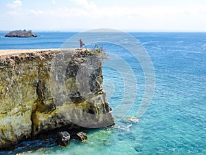 Lombok - A girl and the Pink Beach Cliff