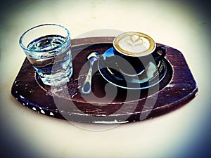 Lomo Cappuccino and Sparkling Water on a Tray