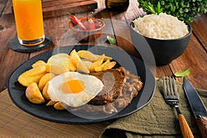 Lomo a lo Pobre - Traditional Chilean Food - Meat, rice, chips and caramelized onion