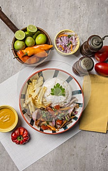 Lomo saltado con papas fritas y arroz sauted meat with onions rice and french fries Peruvian comfort food buffet traditional table