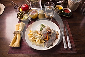 Lomo saltado and french fried with white rice Peruvian comfort food buffet traditional table