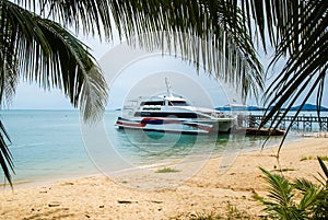 Lomprayah high-speed catamaran stands at the pier, located on a sandy beach . Koh Samui Thailand.14.10.2011