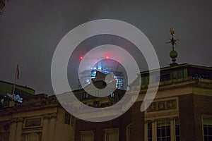 London buildings with fog at night and red lights