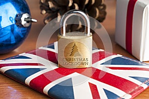 London Christmas lockdown: a lock over a Union Jack flag sorrounded by Christmas decorations show the message