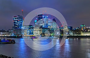 London city skyline at night with skyscrapers against cloudy ski