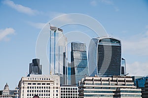 London, England - The bank district of central London with famous skyscrapers and other landmarks at sunset with grey sky - UK