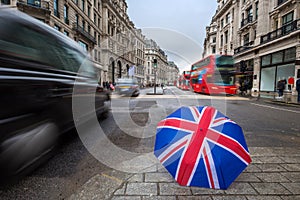 London, England - British umbrella at busy Regent Street with icLondon, England - British umbrella at busy Regent Street with icon