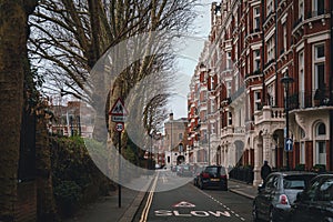 LONDON, ENGLAND, DECEMBER 29, 2018: Facades in London on quietly street with signs of slow speed for school crossing