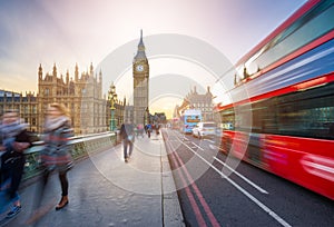 London, England - The iconic Big Ben and the Houses of Parliament with famous red double-decker bus