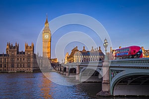 London, England - The iconic Big Ben with Houses of Parliament and traditional red double decker bus