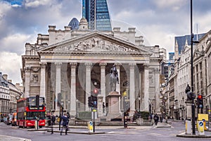 London, England - Iconic red double decker bus and the Royal Exchange building