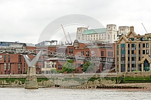 Tourists crossing the Millennium Bridge linking the City of London