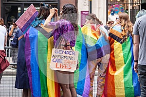 LONDON, ENGLAND- 2nd July 2022: Gender affirming care saves lives placard and Pride in London