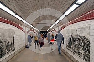 Inside view of one London Underground station with pictures on t