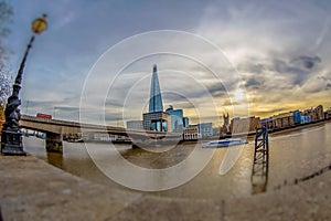 Shard Tower and the banks of Thames river below London Bridge