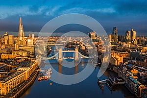 London, England - Panoramic aerial skyline view of London including iconic Tower Bridge with red double-decker bus