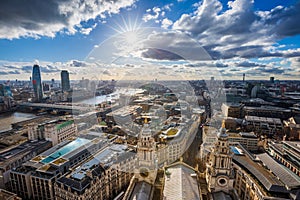 London, England - Panoramic skyline view of London taken from St. Paul`s Cathedral with iconic red double-decker buses