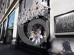 London, England - September 28 2015 : Ice watch window shop with flowers at Oxford street