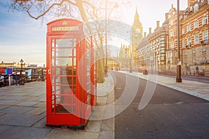 London, England - Traditional Old British red telephone box at Victoria Embankment with Big Ben